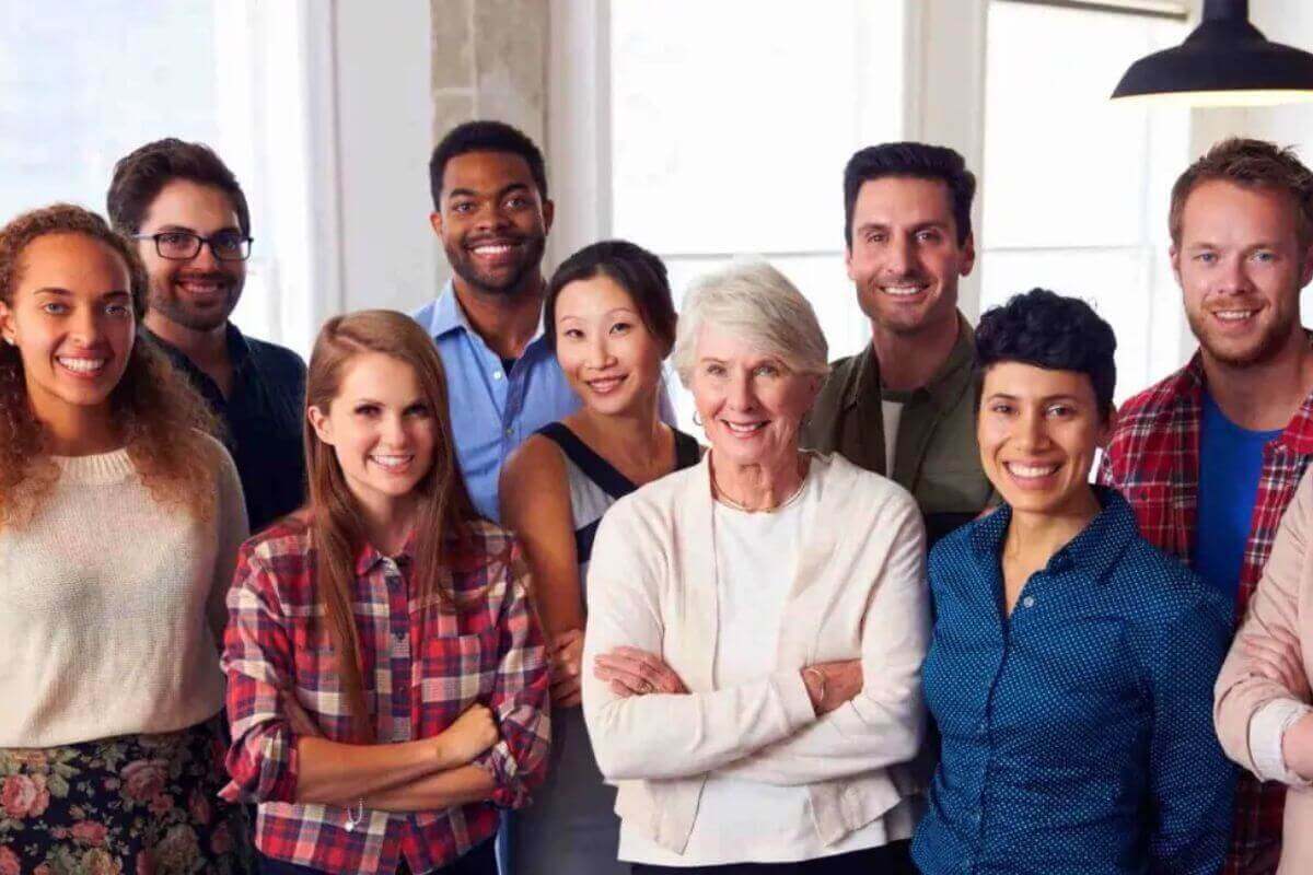 Group of people smiling with arms crossed