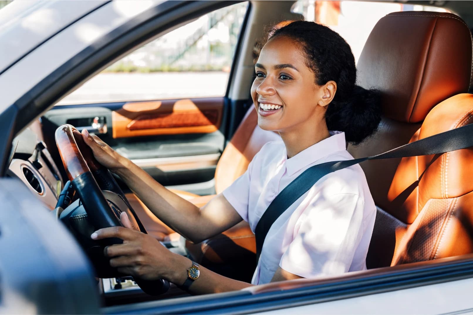 Woman in white shirt driving car