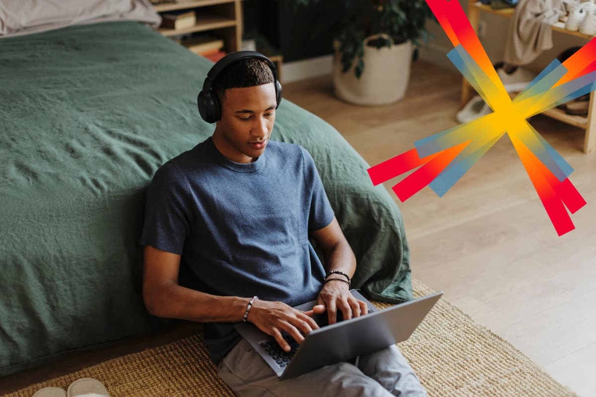 Man working on laptop near bed