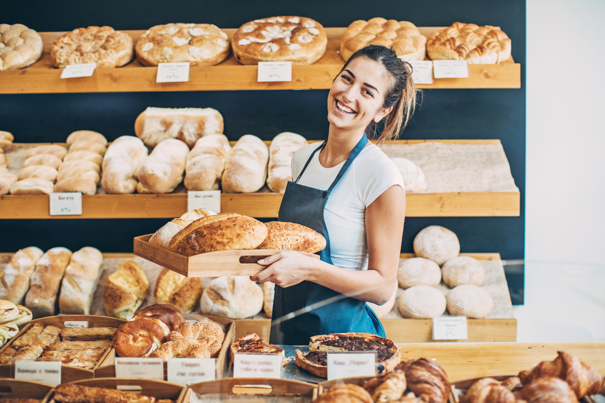 Woman in bakery smiling 